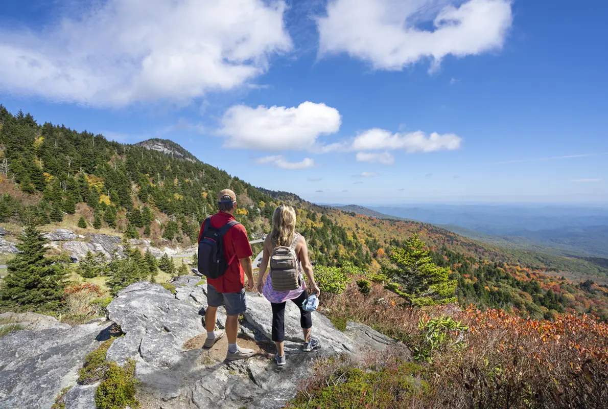 Couple relaxing on top of the autumn mountain.